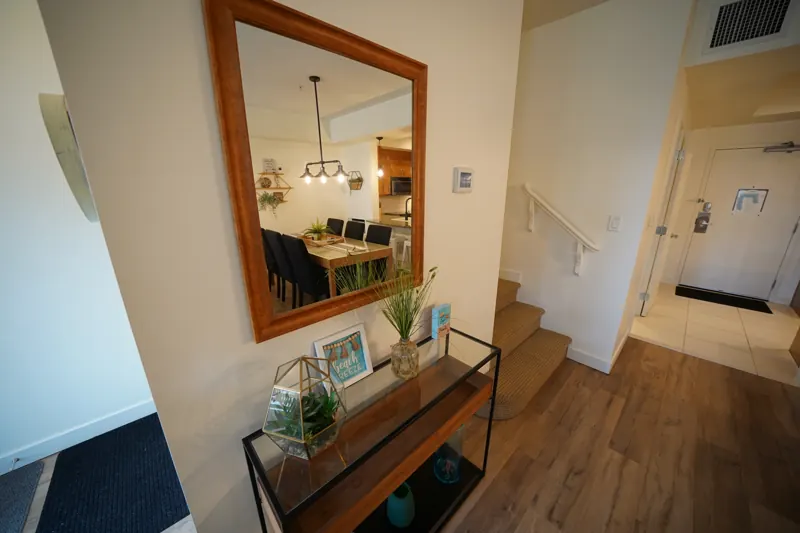 Entry hall with mirror and stairs