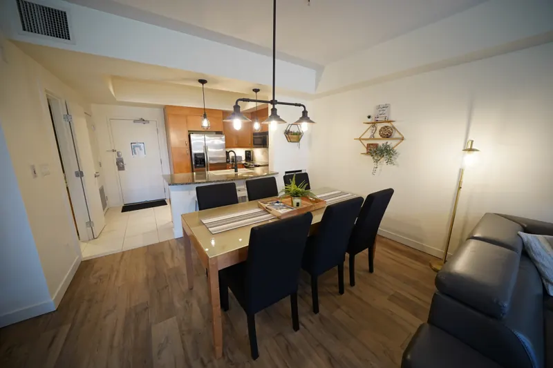Dining table and kitchen with pendant lights