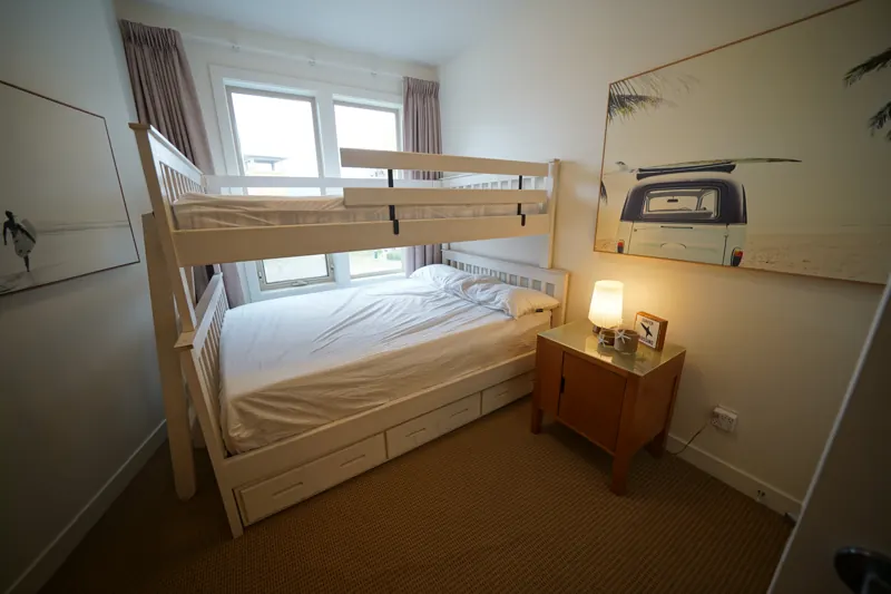 Bunk-bed guest room with lake-facing windows